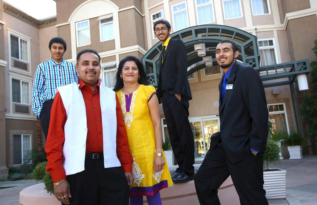 Nick Desai, Sr., with his wife Priti, and three sons, Brandon, left, Nick, and Kevin, at their Holiday Inn Express, in Windsor, are building a new full service Holiday Inn, also in Windsor. (Christopher Chung/ The Press Democrat)