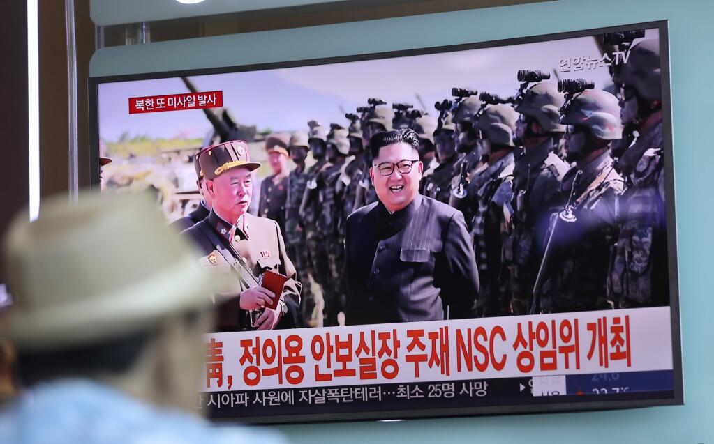 In this Saturday, Aug. 26, 2017, file photo, a man watches a screen showing an image of North Korean leader Kim Jong Un, at the Seoul Train Station in Seoul, South Korea. Three North Korea short-range ballistic missiles failed on Saturday, U.S. military officials said, which, if true, would be a temporary setback to Pyongyang's rapid nuclear and missile expansion. The banners read: 'South Korean Presidential Office, National Security Director Chung Eui-yong chaired a National Security Council meeting.' (AP Photo/Lee Jin-man, File)