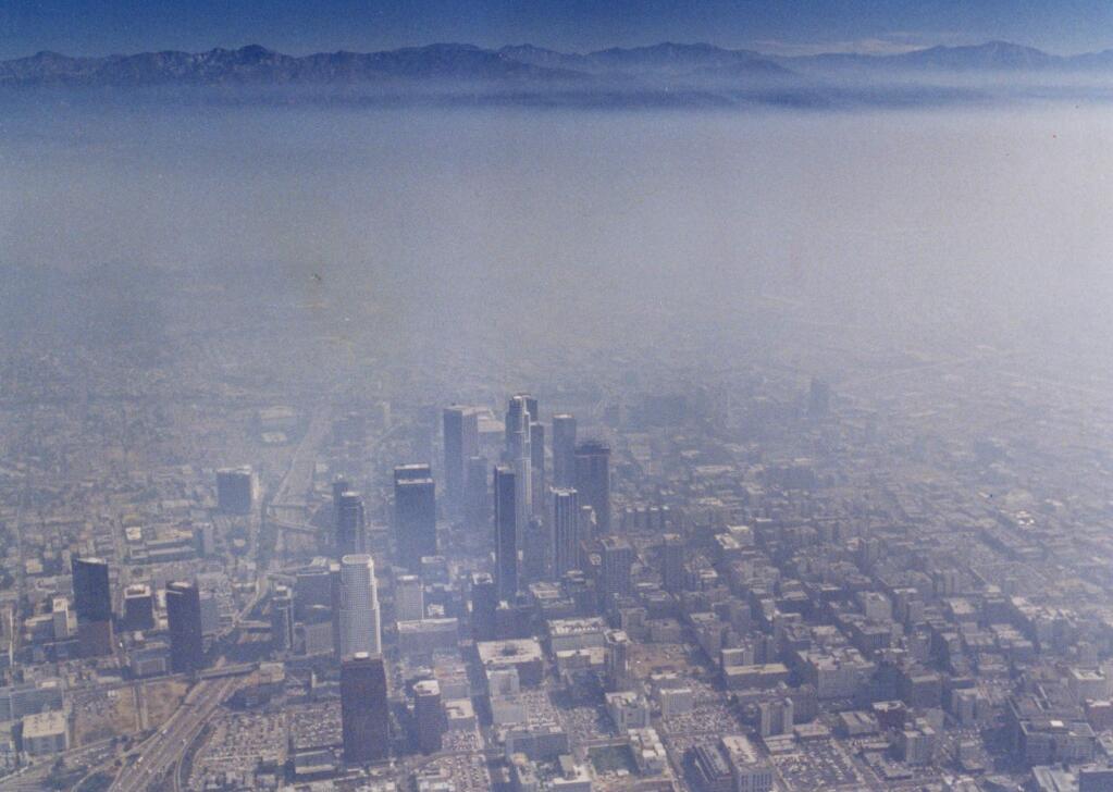 An aerial view of the downtown Los Angeles skyline covered in smog, looking east toward the San Gabriel mountains, in an August 1990 file image. (Robert Durell/Los Angeles Times/TNS)