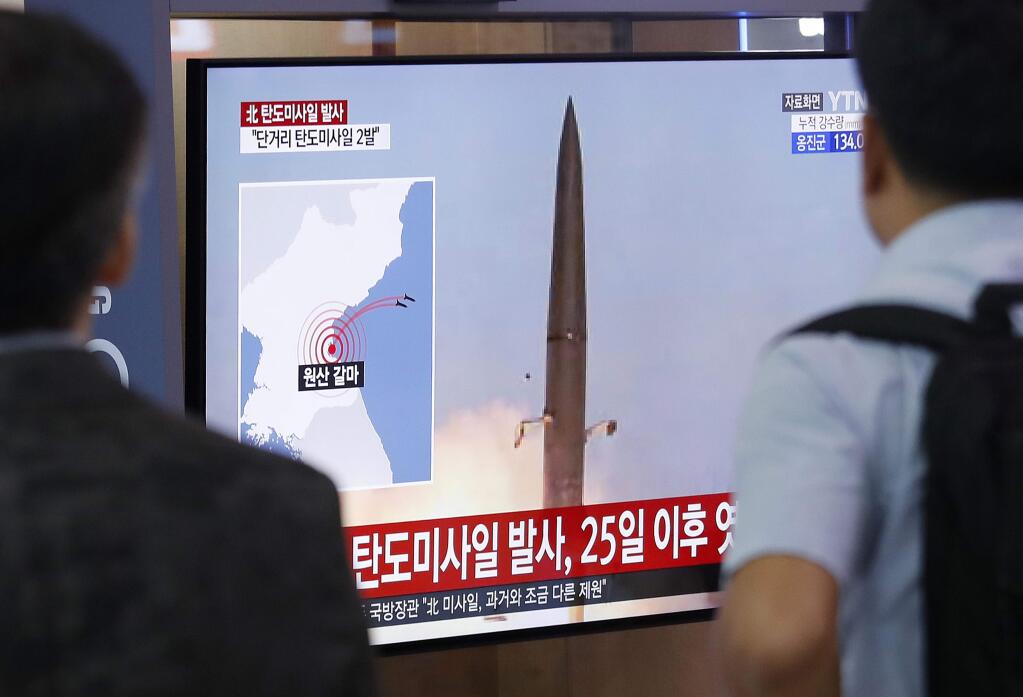 People watch a TV showing a file image of North Korea's missile launch during a news program at the Seoul Railway Station in Seoul, South Korea, Wednesday, July 31, 2019. North Korea fired two short-range ballistic missiles off its east coast Wednesday, South Korea's military said, its second weapons test in less than a week. The Korean letters read: 'North Korea fired since July 25.' (AP Photo/Ahn Young-joon)
