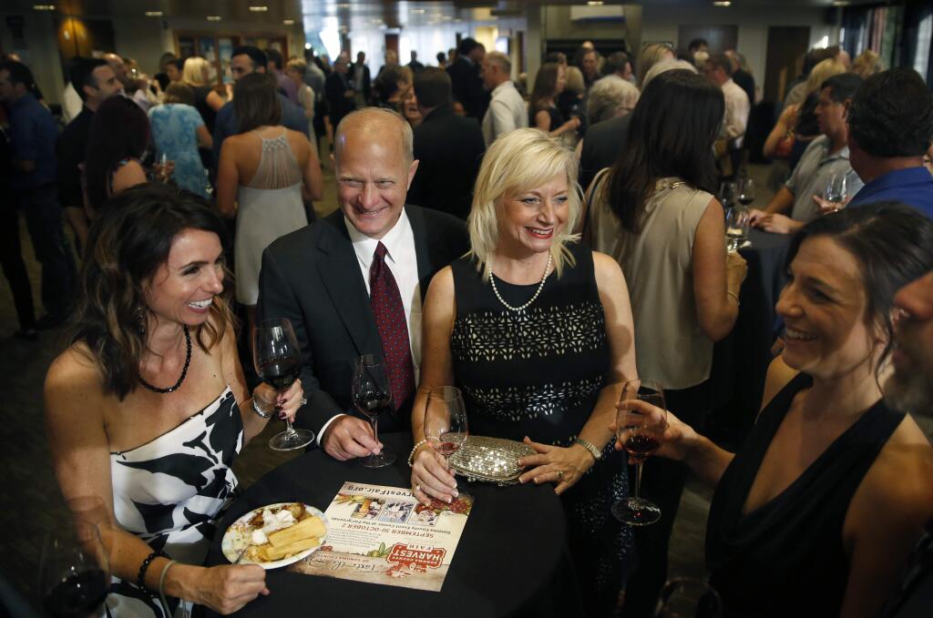 Erica Aquilino, Bryan and Paula Locker, and Megan Sousa enjoy drinks and food during the Harvest Fair awards gala at the Luther Burbank Center for the Arts on Sunday, September 25, 2016 in Santa Rosa, California . (BETH SCHLANKER/ The Press Democrat)