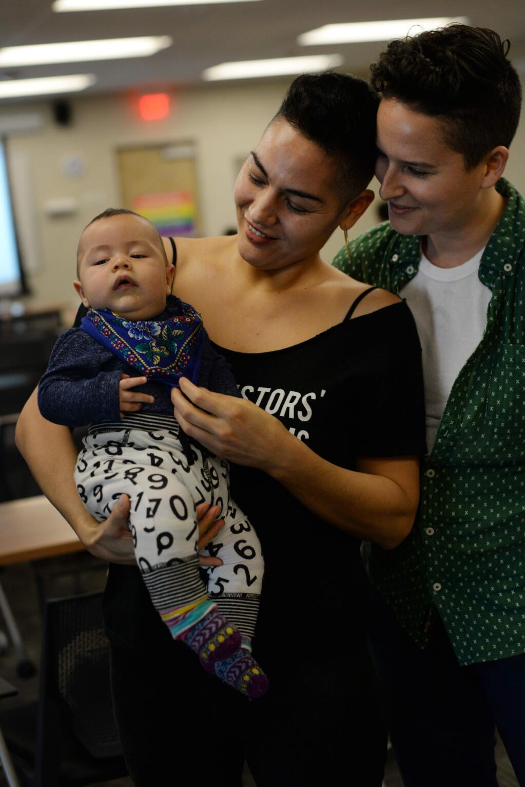 Andrea Ruizquez and her partner Marea Goodman, right, holding their 4-month-old son Feliciano Ruizquez came up from Oakland, Californian to attend the 2nd Annual LGBTQI Family Formation Symposium held Sunday at Social Advocates for Youth Dream Center in Santa Rosa, California. 'We're here just to be around other queer families,' said Ruizquez, January 28, 2018.(Photo: Erik Castro/for The Press Democrat)