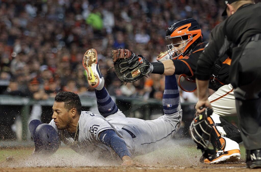 San Diego Padres' Yangervis Solarte, left, is tagged out by San Francisco Giants catcher Buster Posey in the sixth inning of a baseball game Saturday, April 29, 2017, in San Francisco. Solarte was attempting to score on a double by Padres' Hunter Renfroe. (AP Photo/Ben Margot)