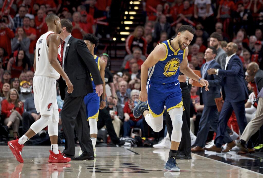 Golden State Warriors guard Stephen Curry, right, reacts after making a 3-point basket against the Portland Trail Blazers during the second half of Game 4 of the NBA Western Conference finals Monday, May 20, 2019, in Portland, Ore. The Warriors won 119-117 in overtime. (AP Photo/Craig Mitchelldyer)