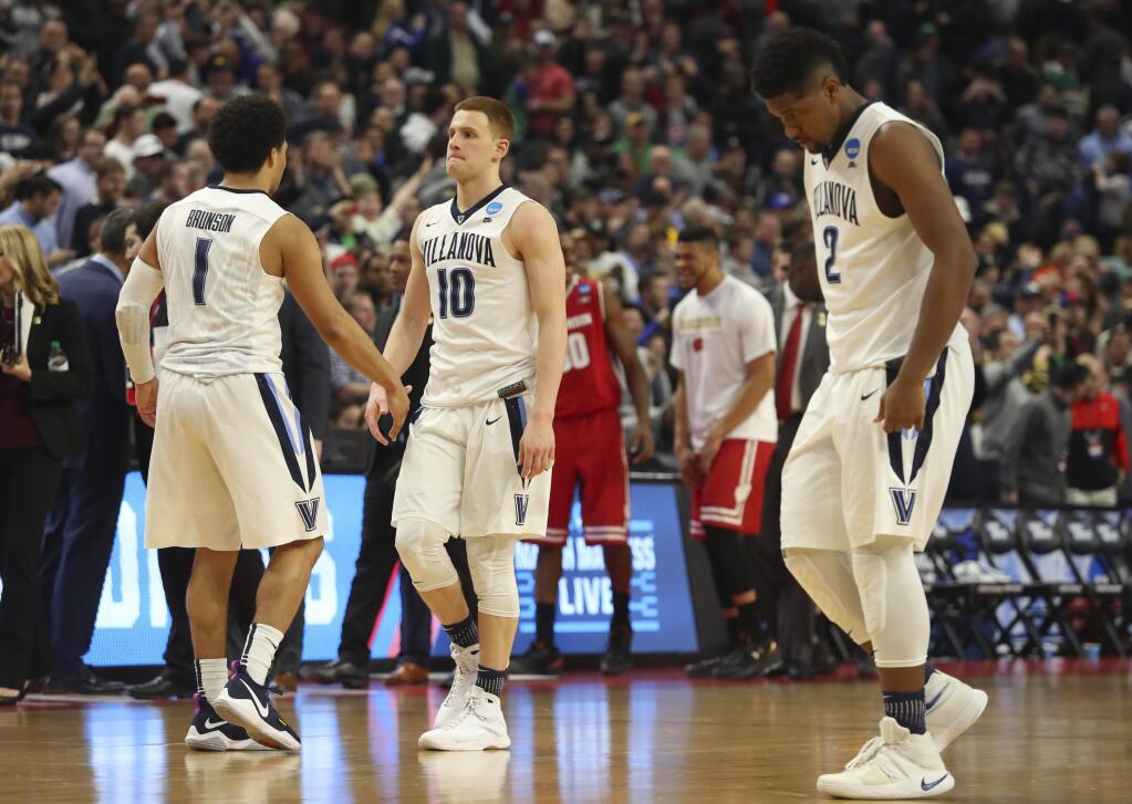 Villanova guard Jalen Brunson (1), guard Donte DiVincenzo (10) and forward Kris Jenkins (2) leave the court after their loss to Wisconsin in a second-round men's college basketball game in the NCAA Tournament, Saturday, March 18, 2017, in Buffalo, N.Y. (AP Photo/Bill Wippert)