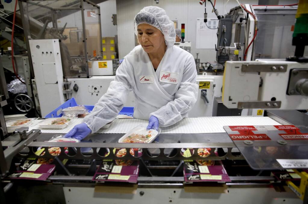 Amys Kitchen employee Maria Rosa Vazquez boxes Thai red curry frozen meals bound for Germany at the production plant on Wednesday, March 11, 2015. (BETH SCHLANKER/ The Press Democrat)
