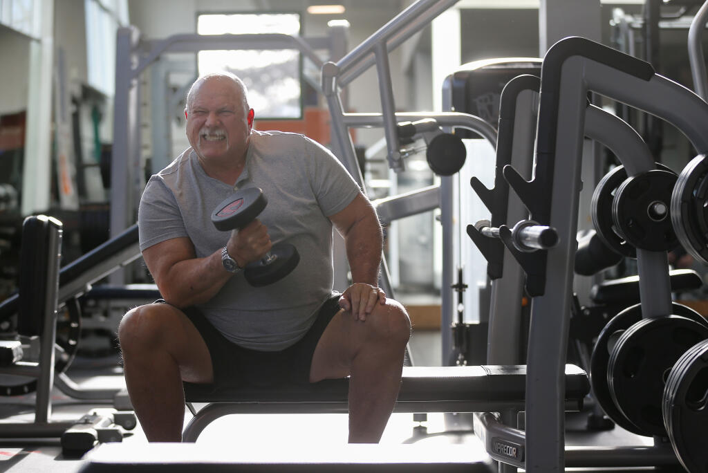 Dave Simmons does biceps curls at Energy Health Clubs in Cotati, Monday, Jan. 8, 2024. (Christopher Chung / The Press Democrat)