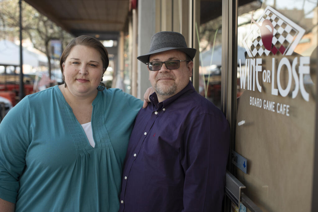 Amanda and Craig Karas stand in front of Wine or Lose Board Game Cafe which the couple had to shut down in July 2020 due to loss of sales from COVID-19 dining restrictions in downtown Petaluma, Calif. on Friday, March 19, 2021. The couple plans on having their food truck, Happy Frenchie, up and running by this summer serving comfort food with a French twist in Napa, Sonoma and Solano county.(Photo: Erik Castro/for The Press Democrat)