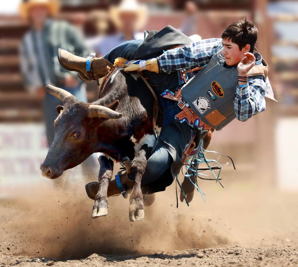 Blake Bishop, 13, of Windsor won the junior steer riding competition on Saturday at the 51st annual Russian River Rodeo in Duncans Mills. (John Burgess/The Press Democrat)