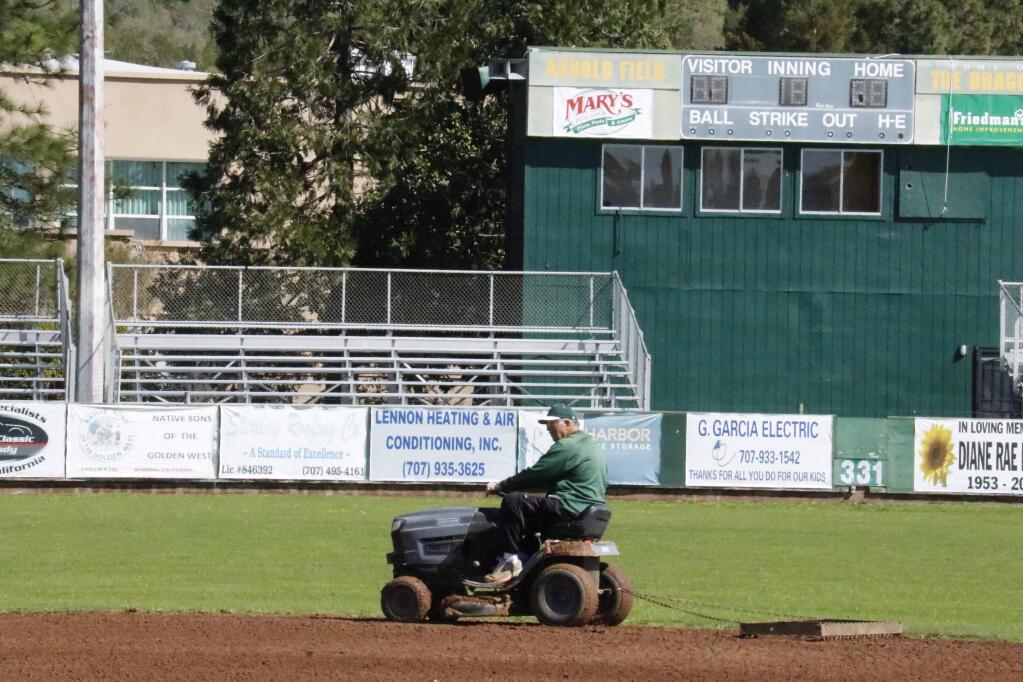 Mario Alioto rakes the infield at Arnold Field, in preparation for games in the wake of this winter's heavy rains. (Christian Kallen/Index-Tribune)