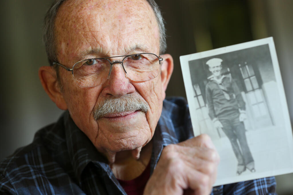 George Hudson holds a photograph of his father, Charles Hudson, a sailor on the USS Oklahoma that died in the attack on Pearl Harbor. Charles Hudson's body was never identified until recently. George Hudson and his wife, Leslie, will attend a reburial ceremony with honors for Charles Hudson at the National Cemetery of the Pacific on Oahu on Sept. 10. (Christopher Chung / The Press Democrat)