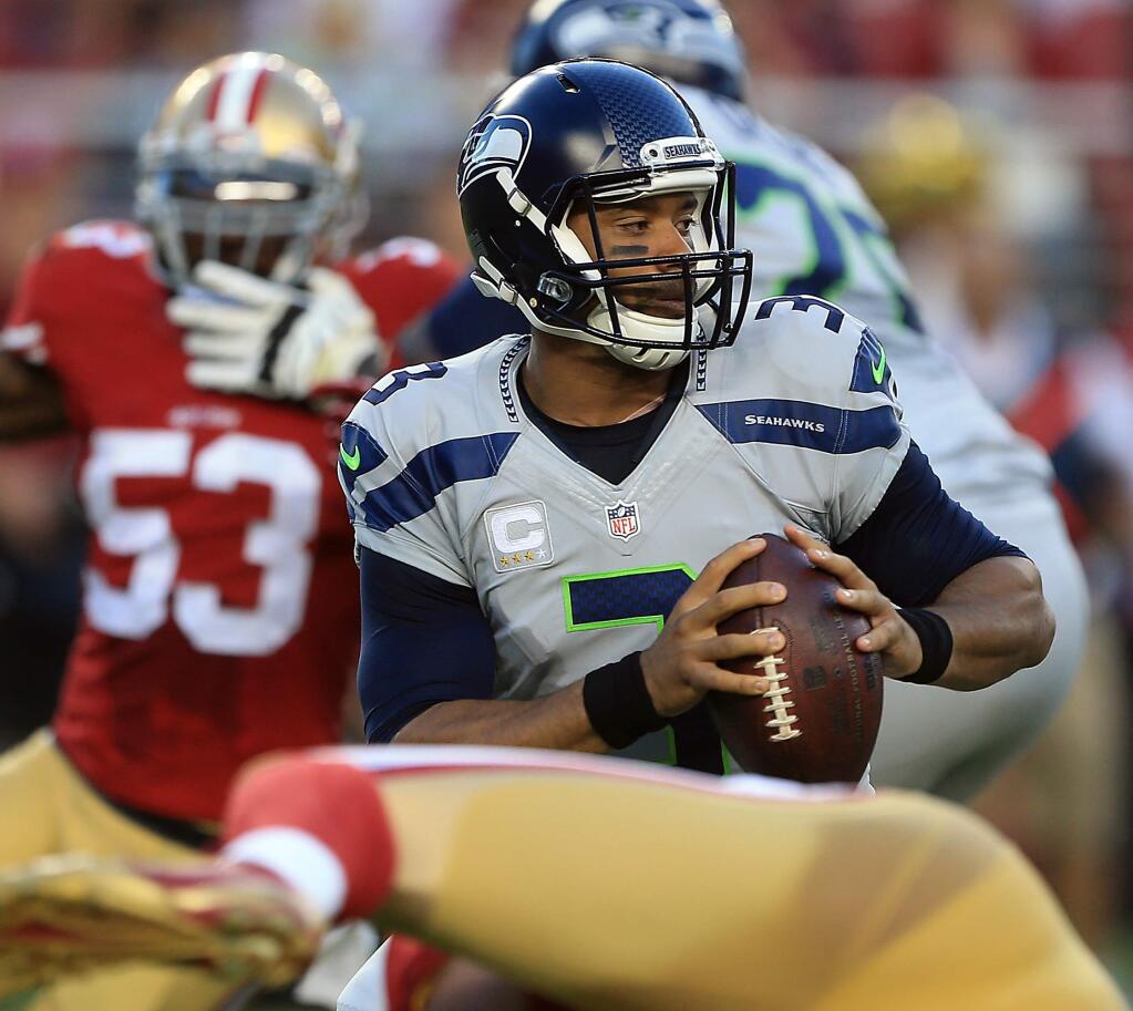 Russell Wilson's arsenal of offensive tools has been limited since his Week 1 ankle injury. (Kent Porter / Press Democrat)