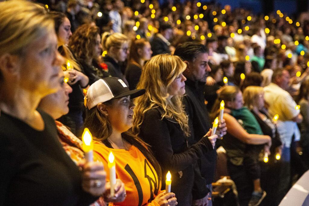 People gather for a candlelight vigil to honor the victims of the shooting at Borderline Bar and Grill in Thousand Oaks. (KENT NISHIMURA / Los Angeles Times)