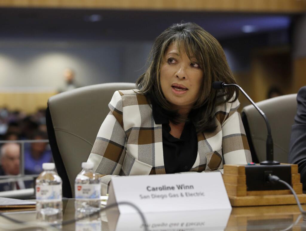 San Diego Gas & Electric Chief Operating Officer Caroline Winn talks about her utility's decision to preemptively shut off power to prevent wildfires this year, during her appearance at an oversight hearing of the Energy, Utilities and Communications Committee at the Capitol in Sacramento, Calif., Monday, Nov. 18, 2019. (AP Photo/Rich Pedroncelli)