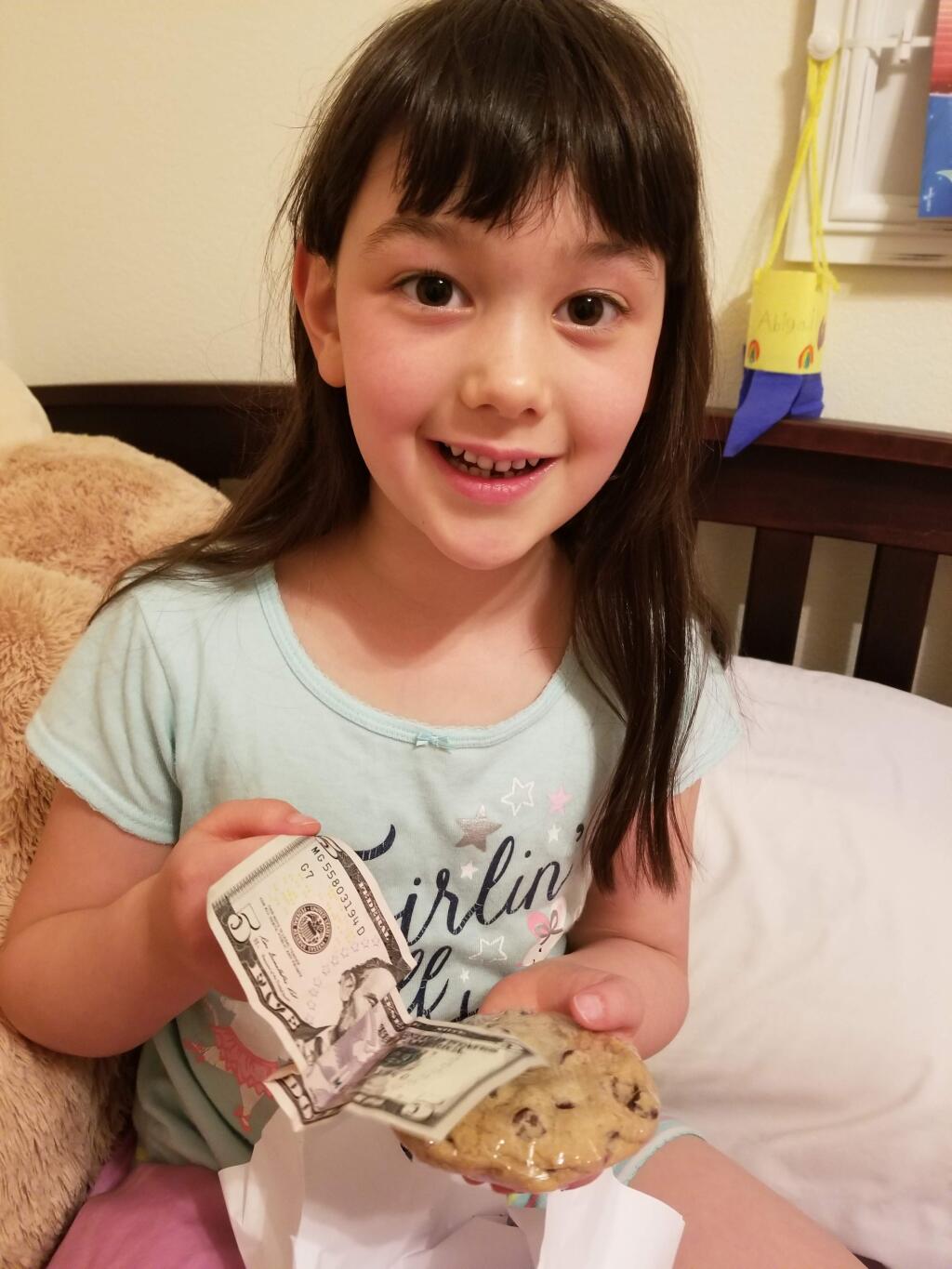 The Tooth Fairy delivered Abigail $5 and a cookie.