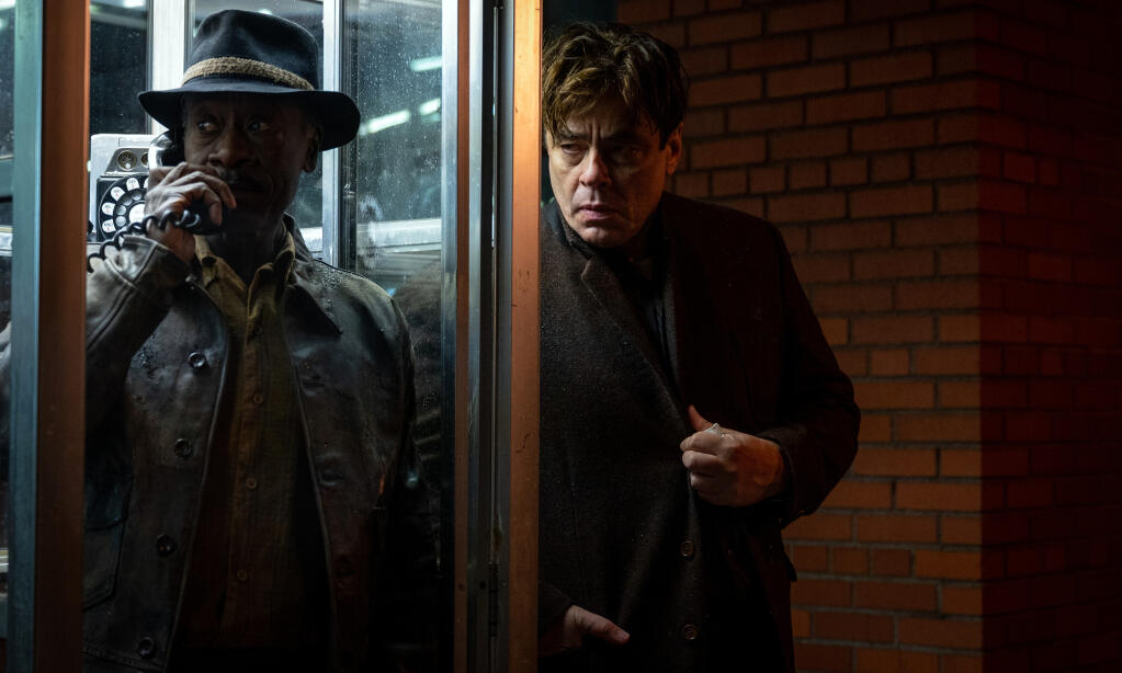 Don Cheadle checks in with the boss as Benicio del Toro lurks, in Steven Soderburg's 'No Sudden Move.' (HBO Max)