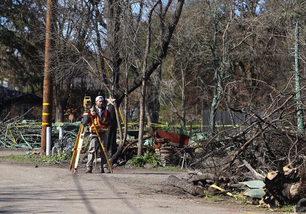 photos by Christopher Chung/The PRess DemocratAlexi Rosichan works on surveying and topographical mapping among burned properties Feb. 20 along O'Donnell Lane in Glen Ellen.