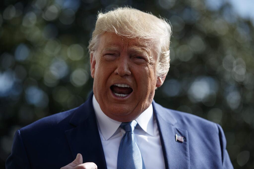 President Donald Trump talks to reporters on the South Lawn of the White House, Friday, Oct. 4, 2019, in Washington. (AP Photo/Evan Vucci)