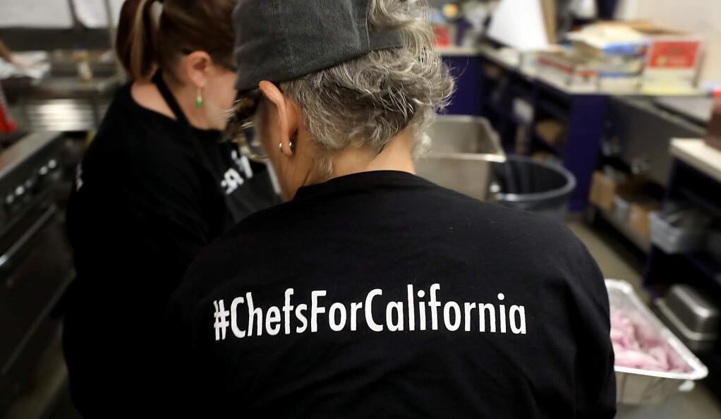 #ChefsForCalifornia volunteer Elsa Corrigan helps out in the kitchen at Middletown High School making food for Mendocino Complex fire evacuees and first responders on Wednesday, Aug. 8, 2018. (KENT PORTER/ PD)