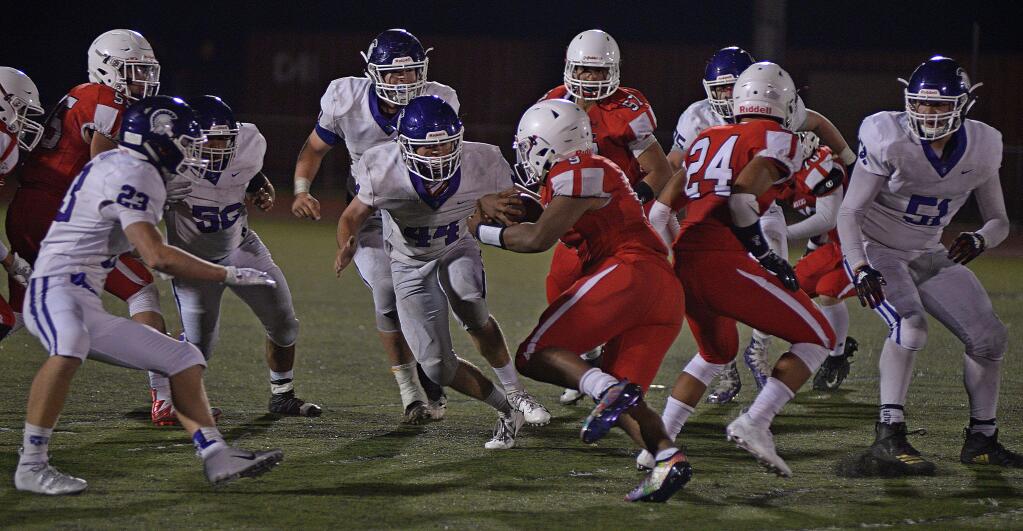 SUMNER FOWLER/FOR THE ASRGUS-COURIERPetaluma defenders, Colton Prieto (23), Daniel Decarli (50), Derrick Pomi and others close in on Montgomery receiver Andre Devall during a game won by Petaluma, 21-7.