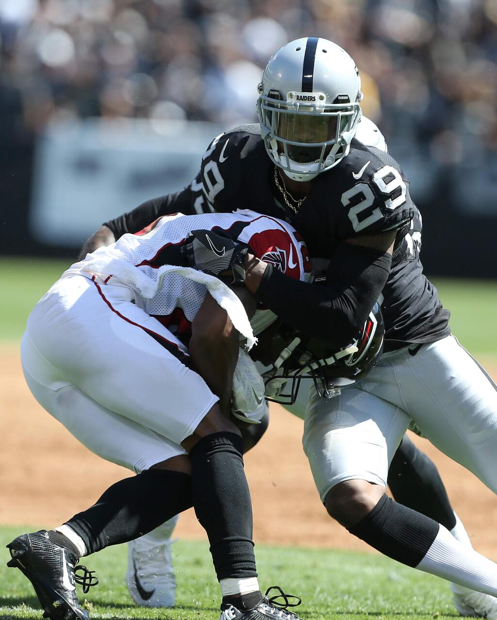 Oakland Raiders cornerback David Amerson tackles Atlanta Falcons wide receiver Taylor Gabriel during their game in Oakland on Sunday, September 18, 2016. The Raiders lost to the Falcons 35-28.(Christopher Chung/ The Press Democrat)