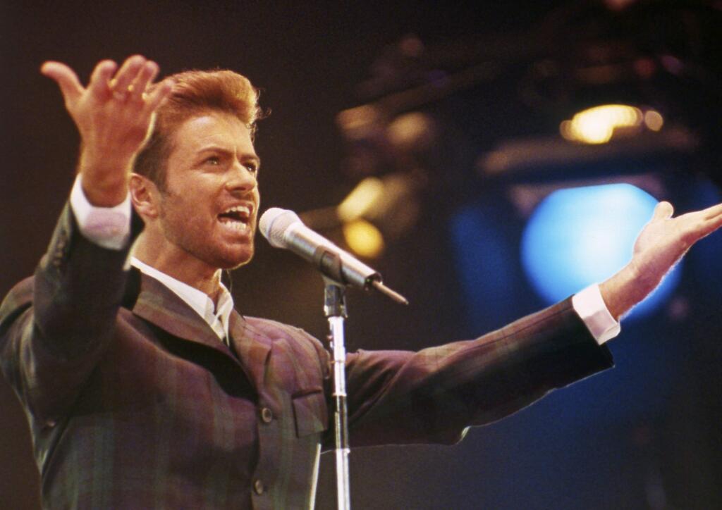 FILE - In this Dec. 2, 1993 file photo, George Michael performs at 'Concert of Hope' to mark World AIDS Day at London's Wembley Arena. According to a publicist on Sunday, Dec. 25, 2016, the singer has died at the age of 53. (AP Photo/Gill Allen)