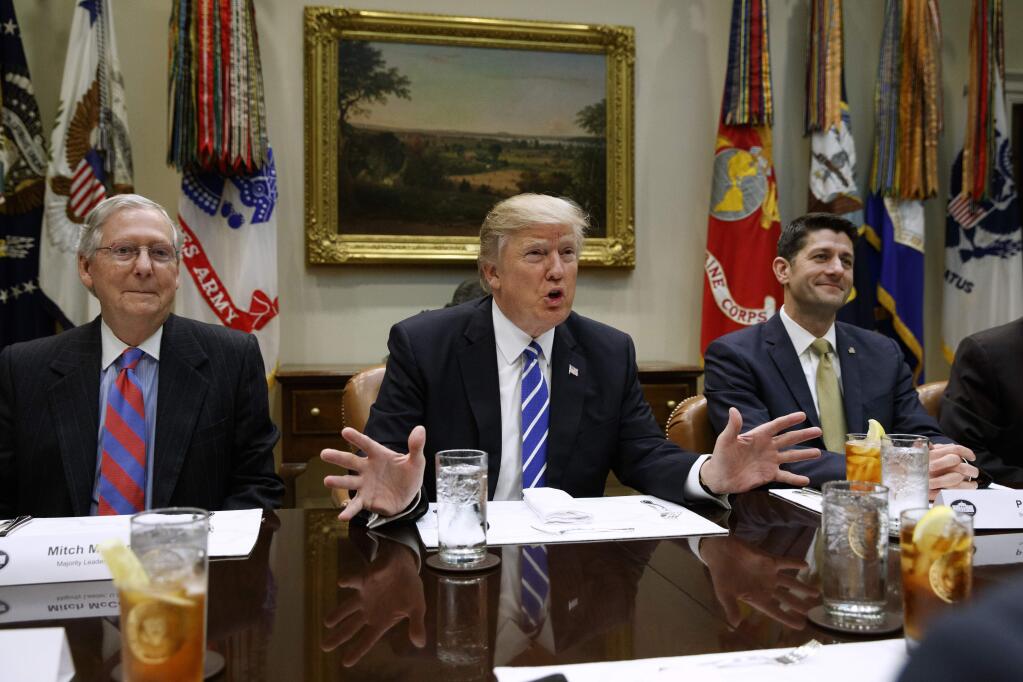 President Donald Trump, flanked by Senate Majority Leader Mitch McConnell of Ky., left, and House Speaker Paul Ryan of Wis., speaks during a meeting with House and Senate leadership, Wednesday, March 1, 2017, in the Roosevelt Room of the White House in Washington. (AP Photo/Evan Vucci)