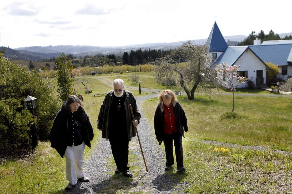 Sister Marti Aggeler, Brother Toby McCarroll, and Sister Julie De Rossi walk up the hill to the chapel for a mid-day communion service at the Starcross community in Annapolis on Wednesday, April 4, 2012. (BETH SCHLANKER/ PD FILE)
