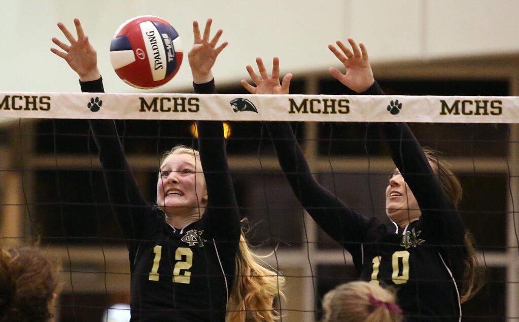 Maria Carrillo's Mia von Knorring, left, and Sally Chesnut, right, go up to block the ball during the game held at Maria Carrillo High School, Wednesday, November 19, 2014. (Crista Jeremiason / The Press Democrat)