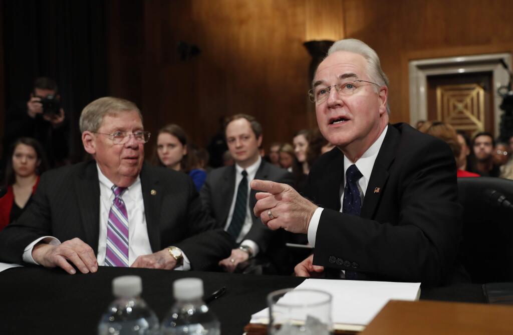 Health and Human Services Secretary-designate, Rep. Tom Price, R-Ga., accompanied by Sen. Johnny Isakson, R-Ga., who introduced him, speaks on Capitol Hill in Washington, Wednesday, Jan. 18, 2017, at his confirmation hearing before the Senate Health, Education, Labor and Pensions Committee. (AP Photo/Carolyn Kaster)