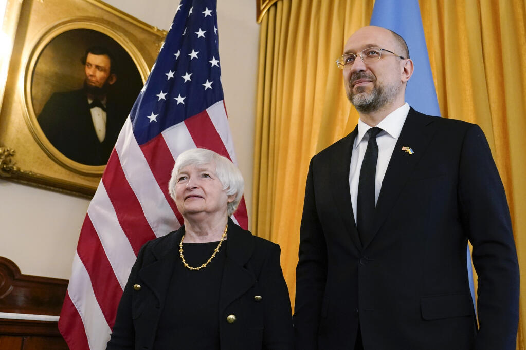 Treasury Secretary Janet Yellen, left, poses for a photo with Prime Minister of Ukraine Denys Shmyhal, right, before their meeting at the Treasury Department in Washington, Thursday, April 21, 2022. (AP Photo/Susan Walsh)
