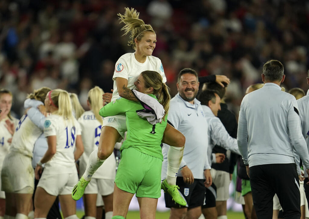 England players celebrate after defeating Sweden in the semifinal round of the women’s European championship tournament Tuesday, July 26, 2022, in Sheffield, England. (Jon Super / ASSOCIATED PRESS)