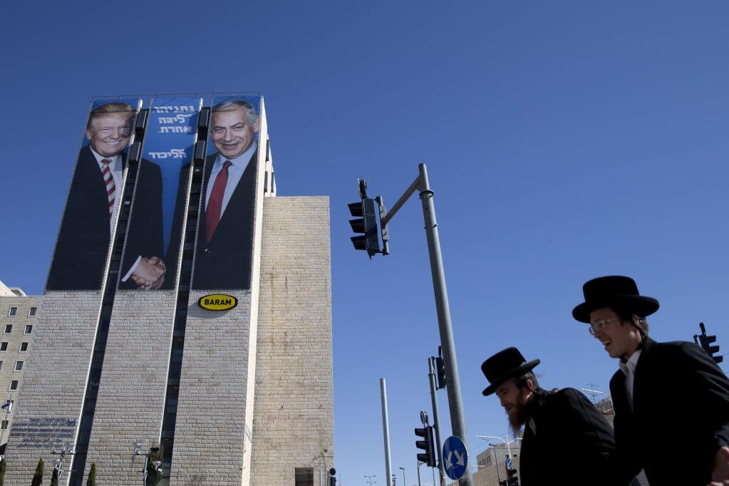 FILE - In this Feb. 4, 2019, file photo, an election campaign billboard shows Israeli Prime Minister Benjamin Netanyahu, right, and U.S. President Donald Trump in Jerusalem. Hebrew on the billboard reads: 'Netanyahu is a different league.' (AP Photo/Oded Balilty, File)