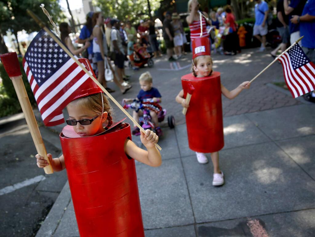 7/5/2014:B3: Dressed as firecrackers, Malia Hughes, 5, left, and her twin sister, Brooke, take part in the Fourth of July Kid's Parade at the plaza in Healdsburg on Friday. PC: Dressed as firecrackers, Malia Hughes, 5, left, and her twin sister, Brooke, take part in the 4th of July Kid's Parade at the plaza in Healdsburg, on Friday, July 4, 2014.(BETH SCHLANKER/ The Press Democrat)