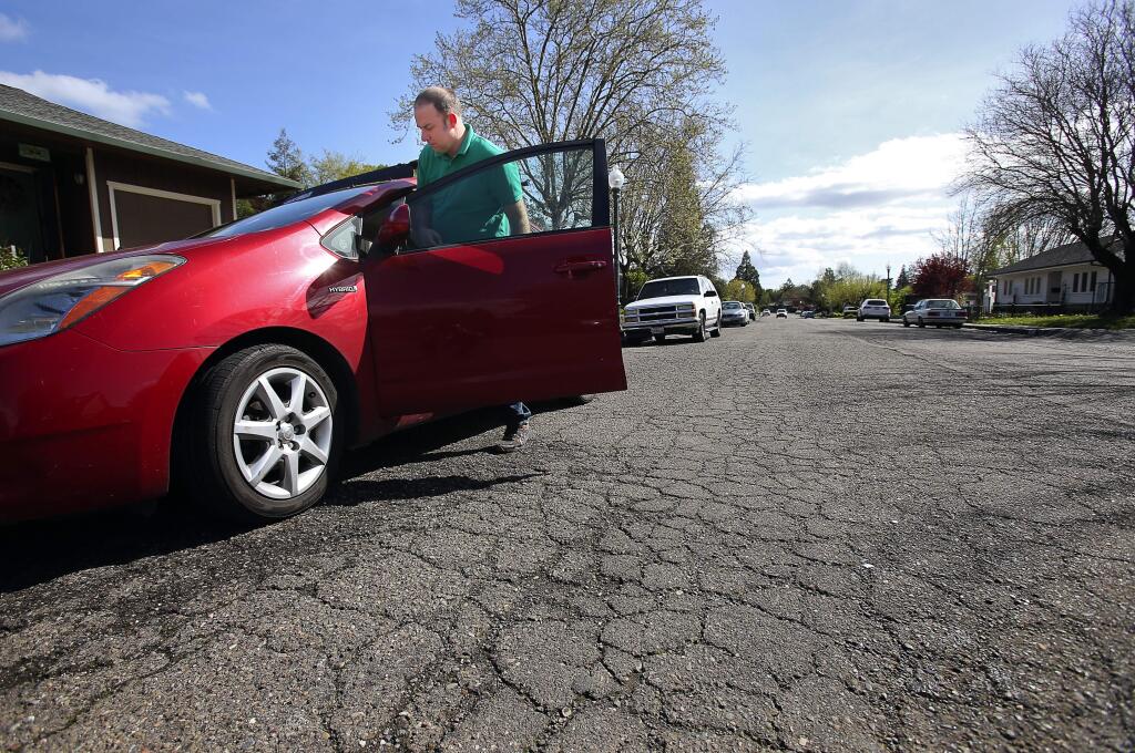 Wade Nobles gets into his car in front of his mother's home on Sunnyside Drive in Healdsburg on Monday, March 14, 2016. Nobles stated that he would like to see the street repaired. 'After 38 years of paying taxes, why not?' (Christopher Chung / The Press Democrat)