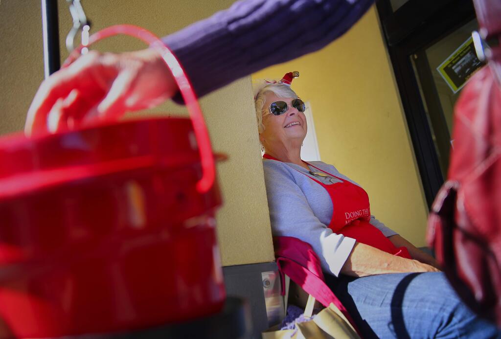 Barbara Slade rings the bell for the Salvation Army in front of G and G Supermarket, in Santa Rosa, on Wednesday, November 25, 2015. (Christopher Chung/ The Press Democrat)