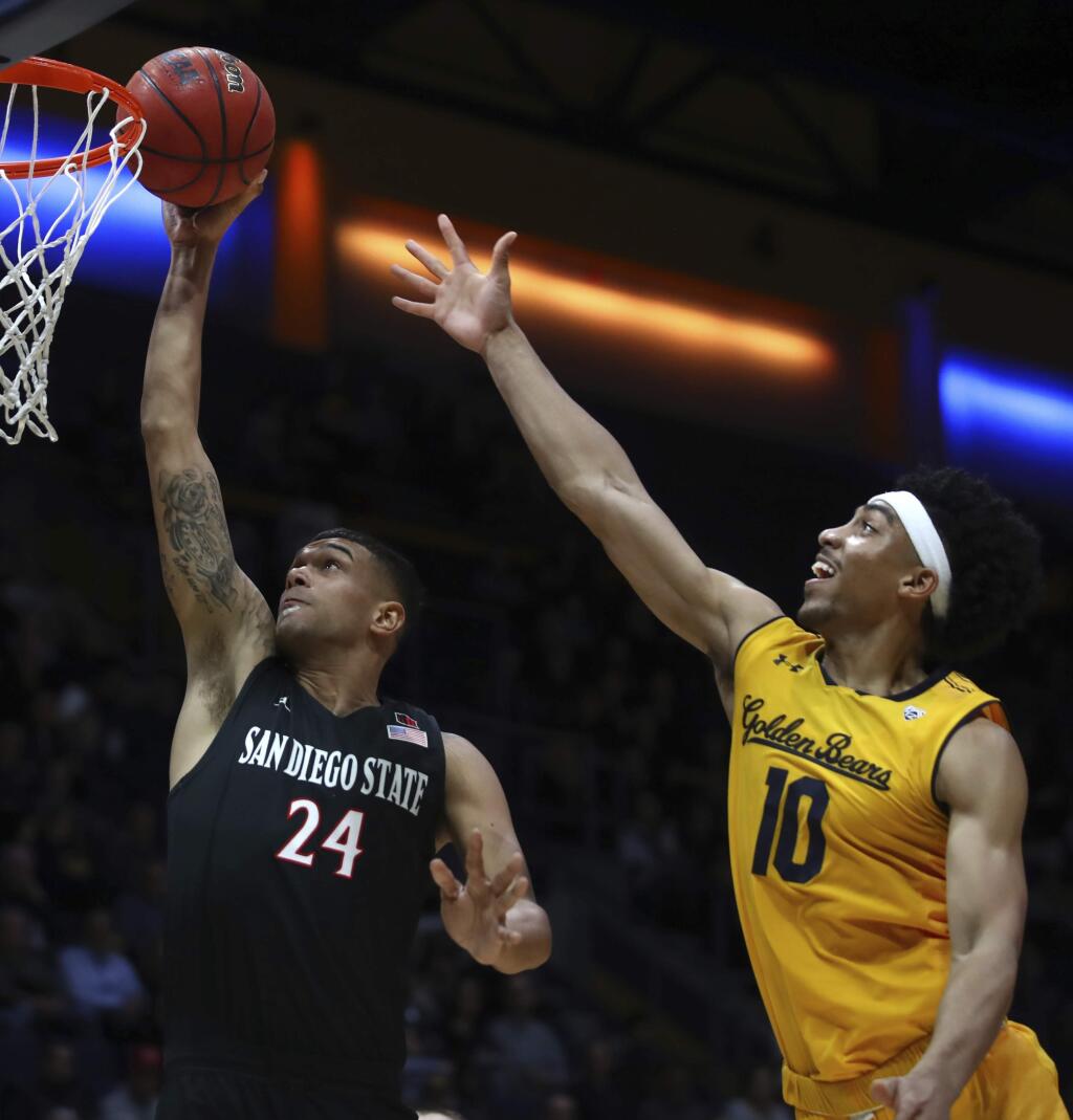 San Diego's Nolan Narain, left, lays up a shot past Cal's Justice Sueing in the second half on Saturday, Dec. 8, 2018, in Berkeley. (AP Photo/Ben Margot)