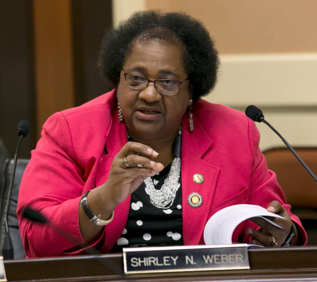 FILE - In this Aug. 23, 2017, file photo, Assemblywoman Shirley Weber, D-San Diego, questions representatives of the California State University system about a recent audit of spending on management staff, during a joint legislative hearing in Sacramento, Calif. Several state lawmakers and the family of a 22-year-old unarmed black man fatally shot by police want to make California the first to significantly restrict when officers can open fire. Democratic Assembly members Weber and Kevin McCarty plan to propose a bill Tuesday, April 3, 2018, that would change the current 'reasonable force' rule to 'necessary force.' (AP Photo/Rich Pedroncelli, File)