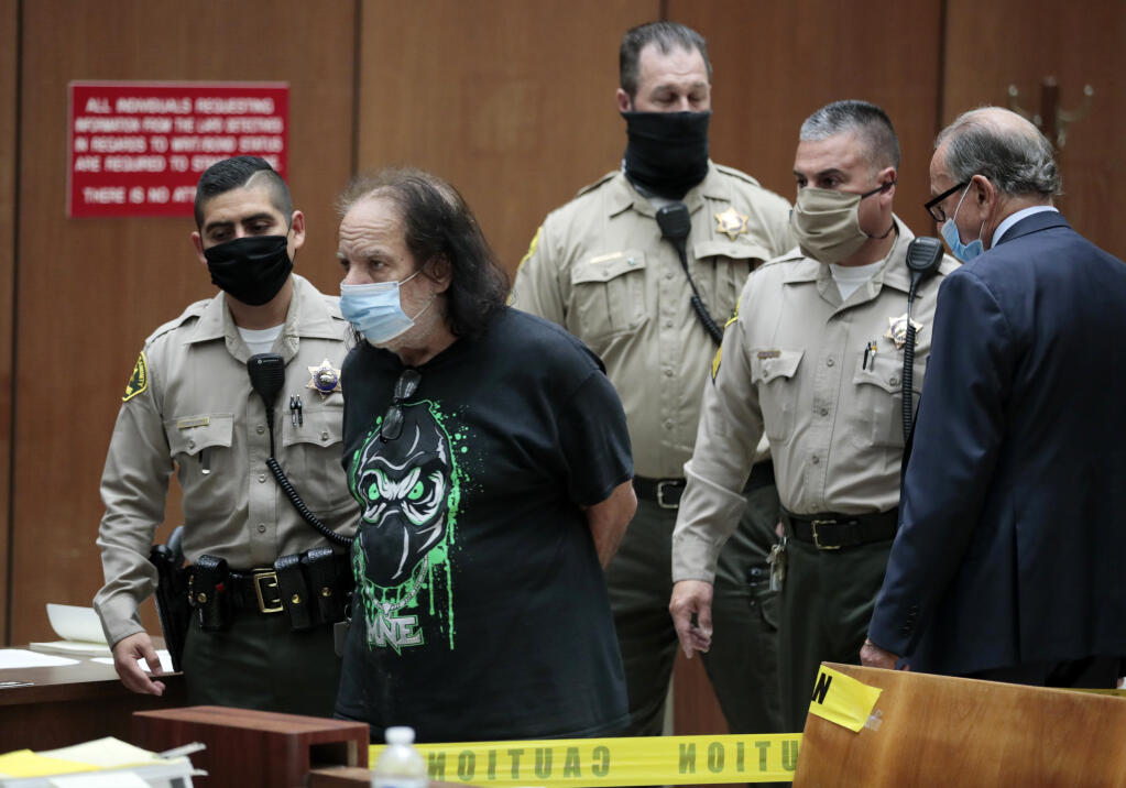 Adult film star Ron Jeremy appears in court with his attorney Stuart Goldfarb, right, upon being charged with sexually assaulting four women in Dept. 30 at LA Superior Court in Los Angeles on Tuesday, June 23, 2020.    Los Angeles County prosecutors say Jeremy has been charged with raping three women and sexually assaulting a fourth. (Robert Gauthier / Los Angeles Times via AP, POOL)