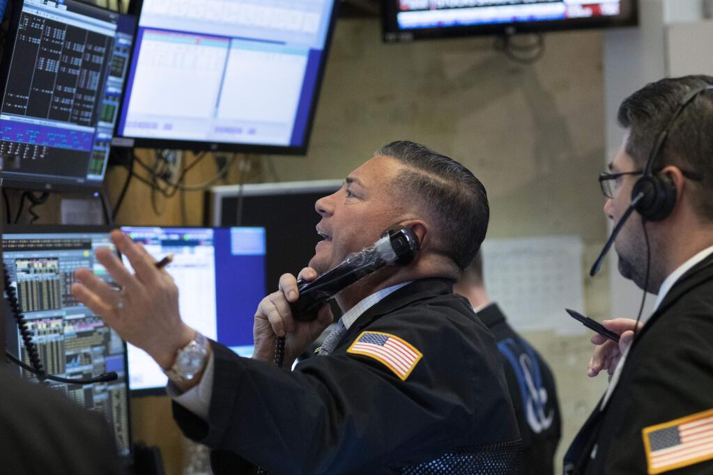 Traders work at the New York Stock Exchange as the market closes, Wednesday, March 18, 2020 in New York. Major U.S. stock indexes closed sharply lower on Wall Street Wednesday as fears of a prolonged coronavirus-induced recession took hold. The Dow industrials lost more than 1,300 points, or 6.3%. After a brutal few weeks, the Dow has now lost nearly all of its gains since President Trump's inauguration. (AP Photo/Mark Lennihan)