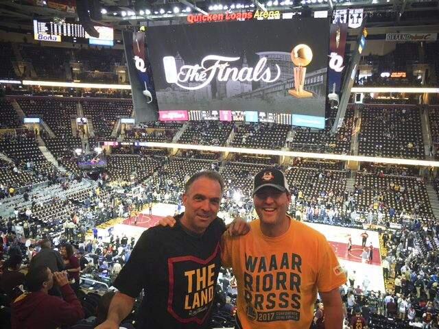 SUBMITTED PHOTOMike Candau, left, and friend Sean McGuinn at the Quicken Loans Arena in Cleveland. Candau is wearing a 'Defend the Land' t-shirt handed out at the game, while McGuinn is in a Warriors' t-shirt.