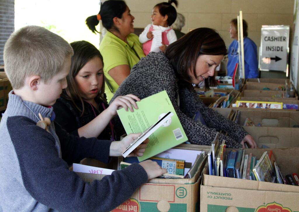 Bill Hoban/Index-TribuneRenise Chiotti looks for some books for her daughter, 9-year-old Gianna, while Gianna and Derek Bell, 9, look for a few of their own Wednesday at the first day of the Friends of the Sonoma Library November book sale. The sale runs through Saturday at the library, 755 W. Napa St., Sonoma.