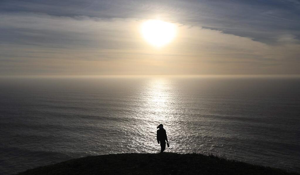 Sonoma State University student Max Dumstorff of San Diego, gets in a hike after the fog dissipates along the Sonoma County Coastline near Goat Rock State Beach, Friday Jan. 1, 2018. A pristine view as far as the eye can see, the Trump administration has renewed the prospect of offshore oil drilling along the Pacific coast and the reduction of marine sanctuaries. (Kent Porter / The Press Democrat) 2018