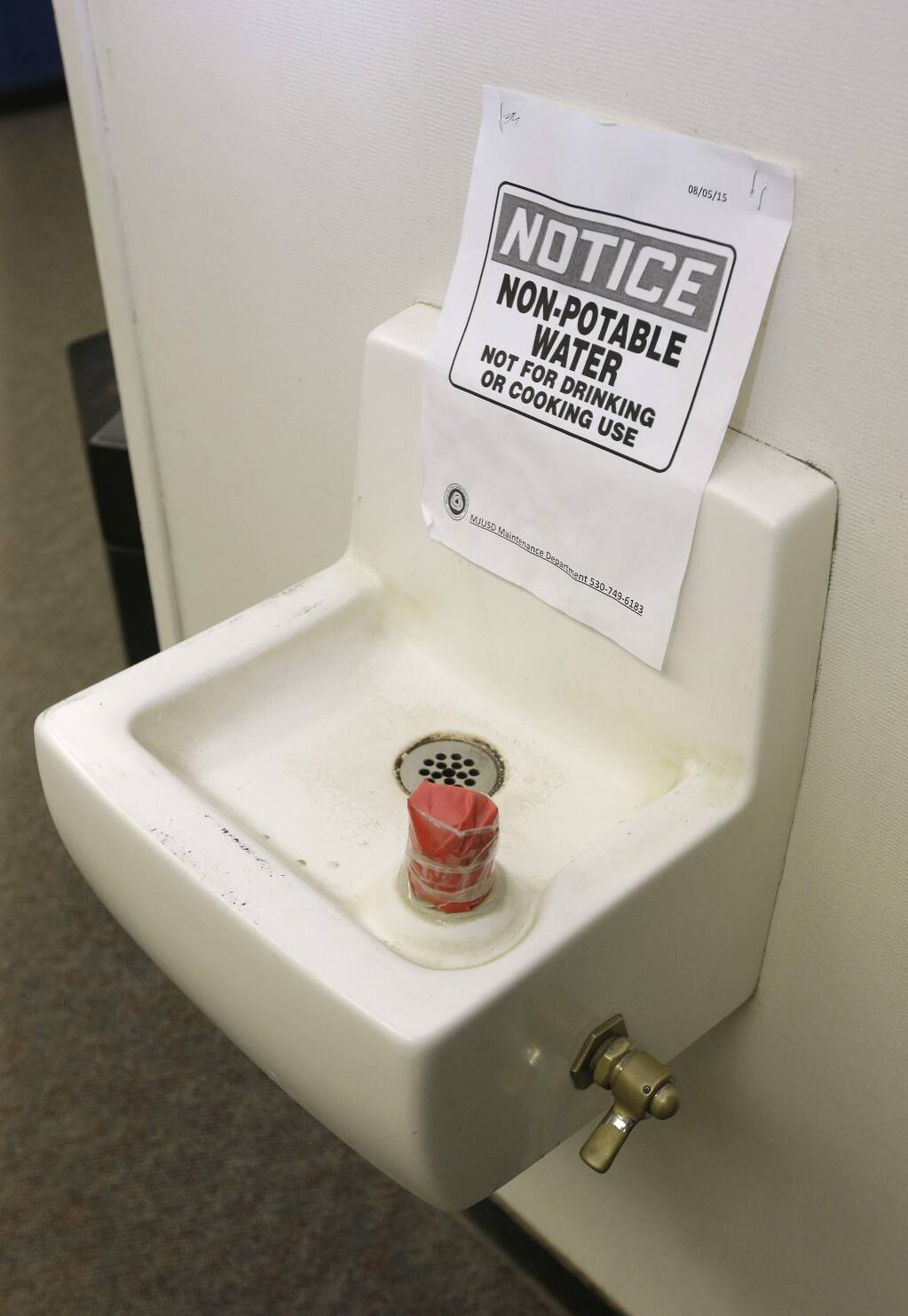 FILE - In this April 6, 2016, file photo tape covers the spout and a sign warns students not to use this water fountain at Foothill Intermediate School in Loma Rica, Calif. Many public water systems in California serving schools, parks, prisons and neighborhoods have found lead at levels unsafe for drinking. The California Senate has rejected on Wednesday, May 15, 2019, a new tax proposed by Gov. Gavin Newsom on most residential water bills, opting instead to use existing tax dollars to improve drinking water in some of the state's poorest areas. (AP Photo/Rich Pedroncelli, File)