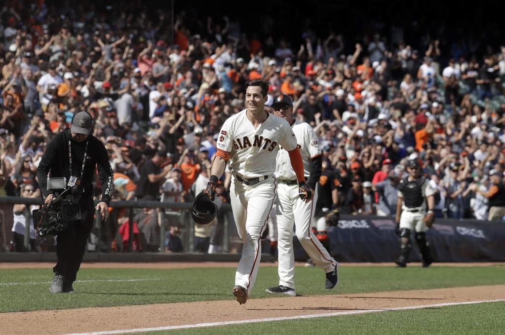 The San Francisco Giants' Mike Yastrzemski, center, celebrates after hitting a solo home run against the New York Mets during the 12th inning in San Francisco, Sunday, July 21, 2019. (AP Photo/Jeff Chiu)