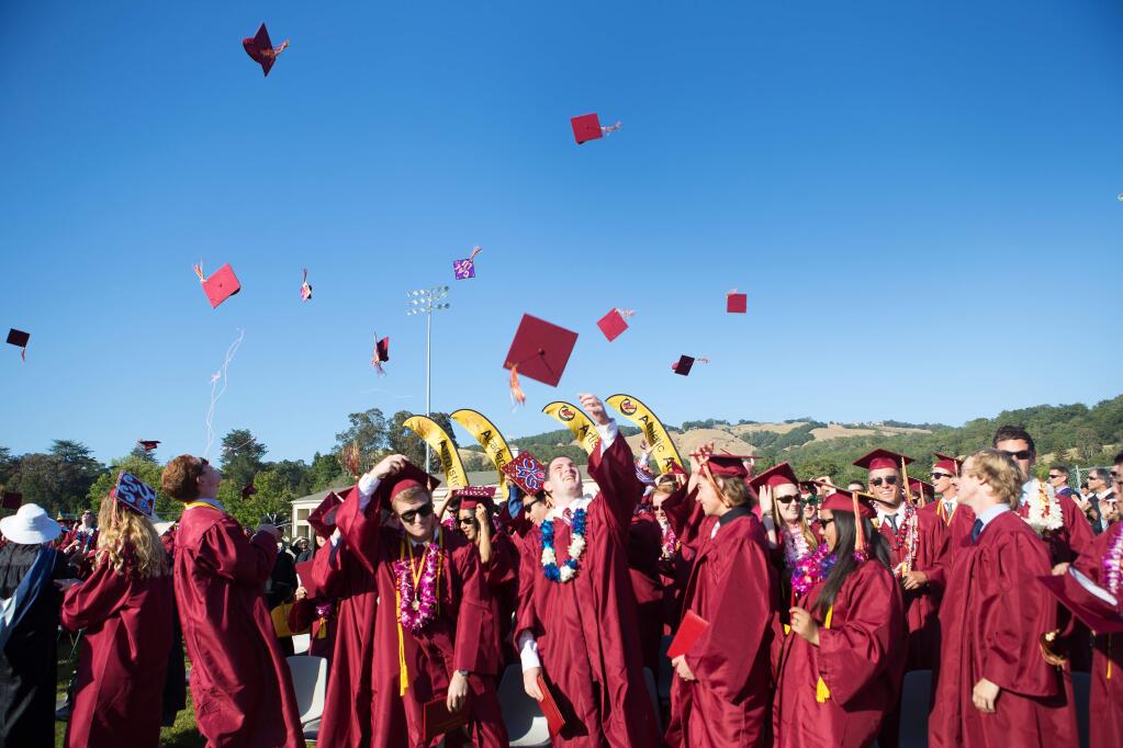Cardinal Newman Graduating seniors toss their hats following commencement ceremonies. (Photo by Charlie Gesell for the Press Democrat)