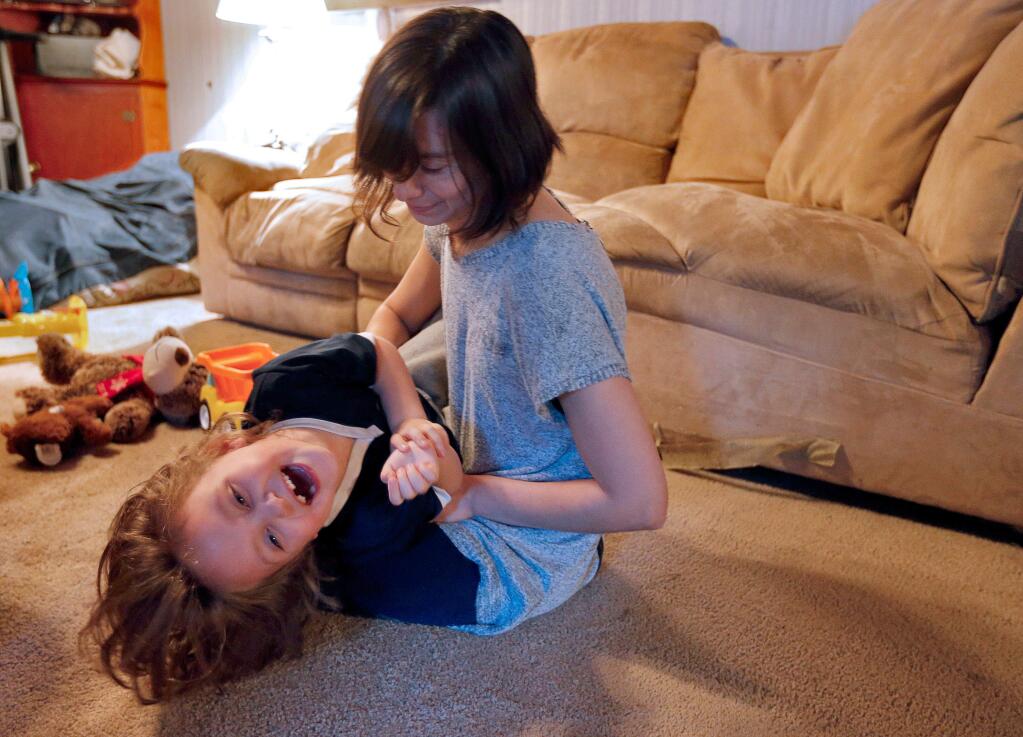 Dominique Soileau plays with adopted foster child Kymber McPherson, 5, at their home in Guerneville, on Tuesday, December 27, 2016. (Alvin Jornada / The Press Democrat)