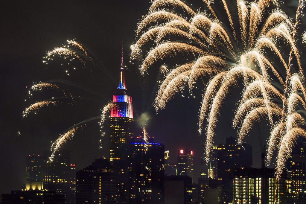With the New York City skyline in the background fireworks explode during an Independence Day show over the East River, Tuesday, July 4, 2017, in New York. (AP Photo/Andres Kudacki)