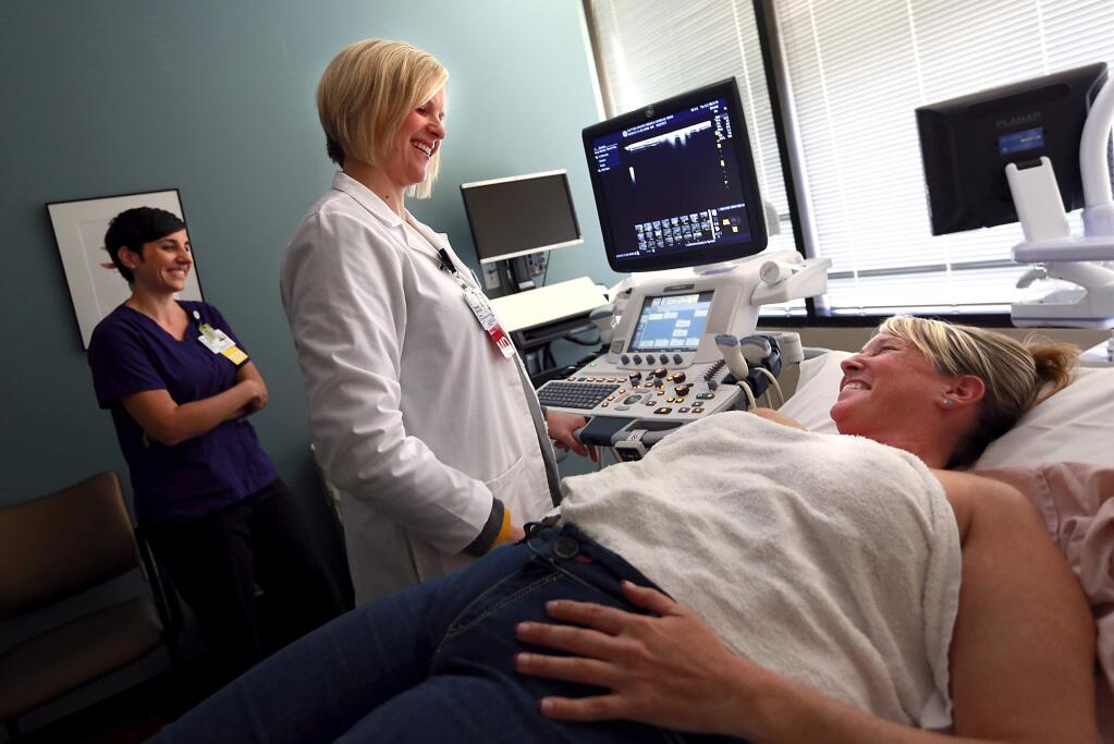 Dr. Gretchen Smith gives Nikki Canelis of Cazadero good news after an ultrasound found no new signs of cancer after surgery last August at the Sutter Nortbay Health Plaza Breast Cancer Center in Santa Rosa. (Photo by John Burgess/The Press Democrat)