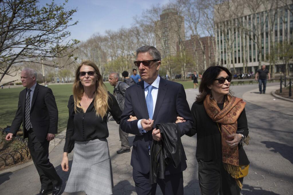 Actress Catherine Oxenberg, left, departs with Stanley Zareff and Toni Natalie, who is Keith Raniere's ex-girlfriend, following the arraignment of NXIVM leader Raniere in federal court on Friday, April 13, 2018, in New York. Oxenberg's daughter India has been named as a co-conspirator in a criminal complaint against Raniere. (AP Photo/Kevin Hagen)